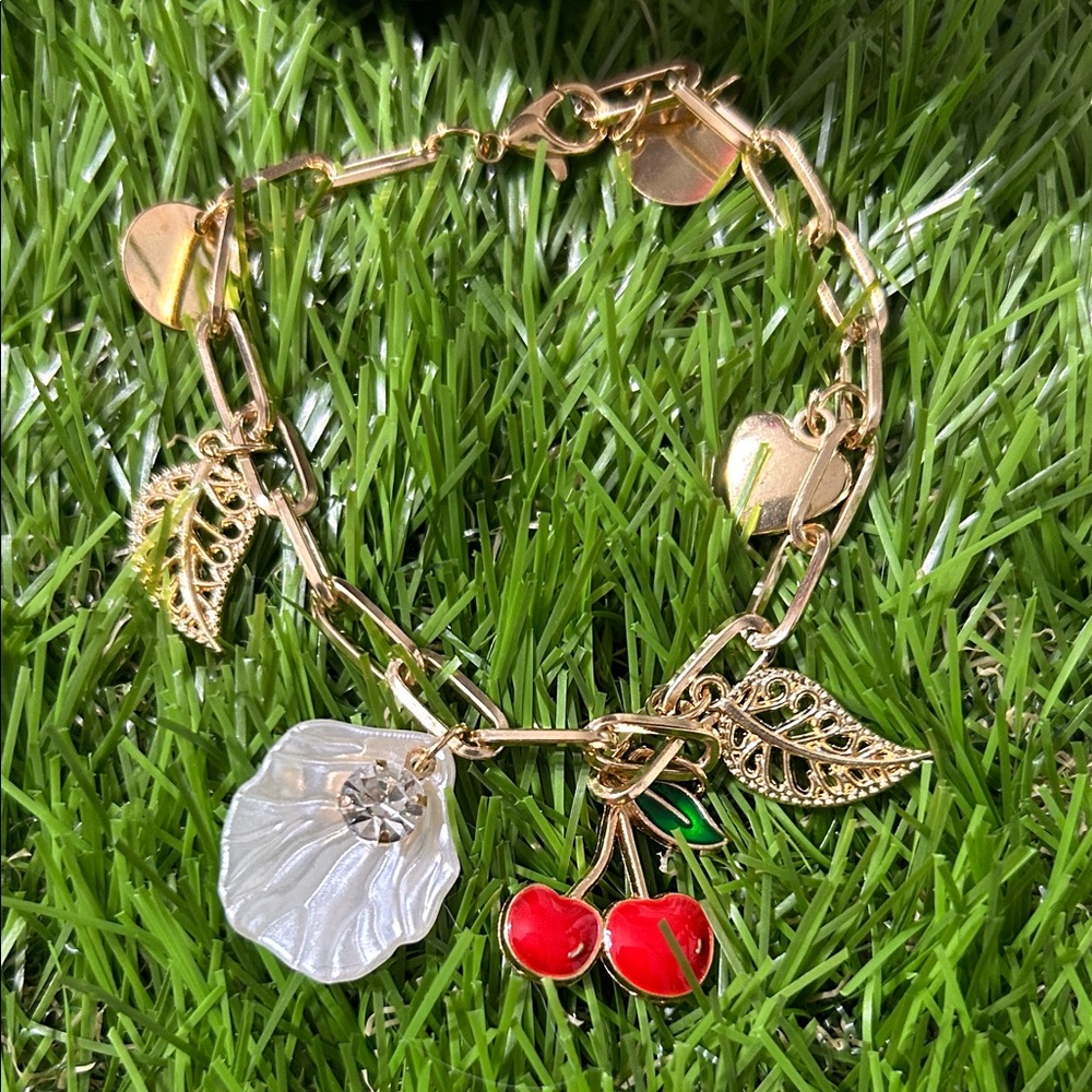 Elegant Gold Bracelet with Red and White Charms
